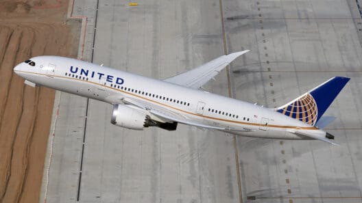 a plane flying over a runway