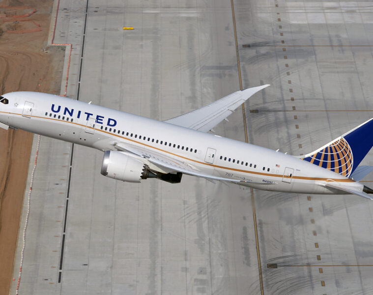 a plane flying over a runway