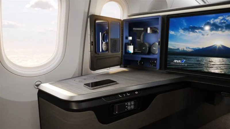 a small cabinet with a screen and a phone on a table