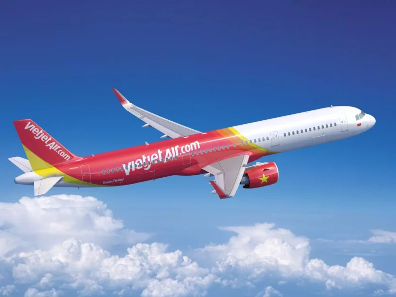 a red and white airplane flying in the sky