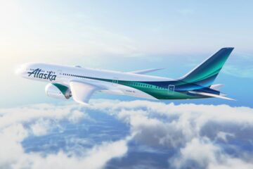 a white and green airplane in the sky