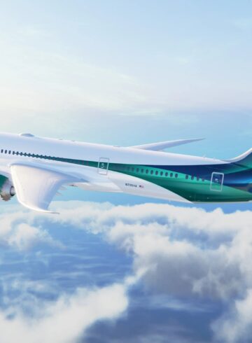 a white and green airplane in the sky