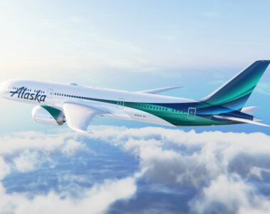 a white and green airplane in the sky