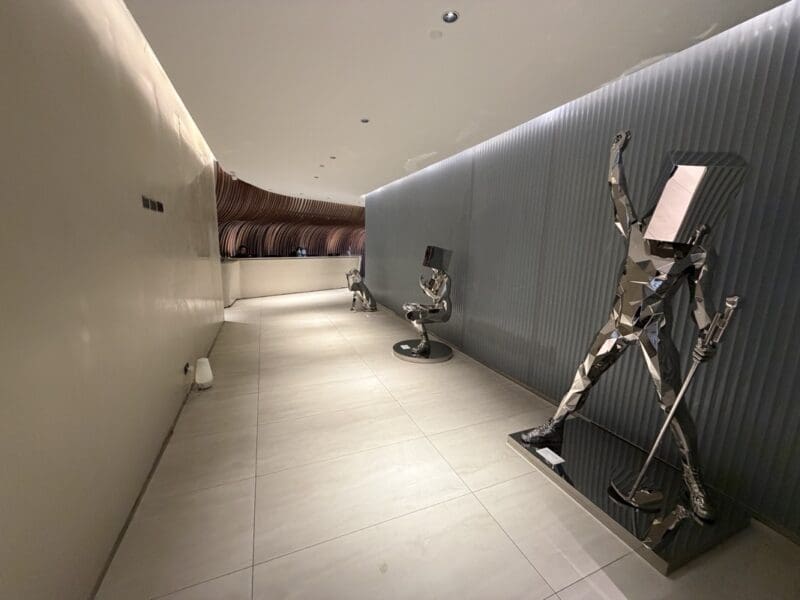 a hallway with a metal sculpture