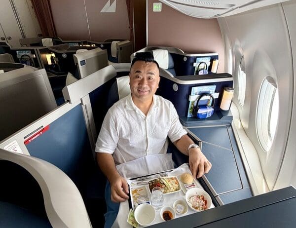 a man sitting in a chair with a tray of food