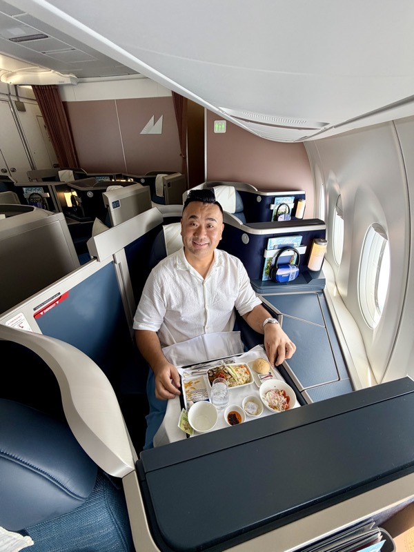 a man sitting in a chair with a tray of food