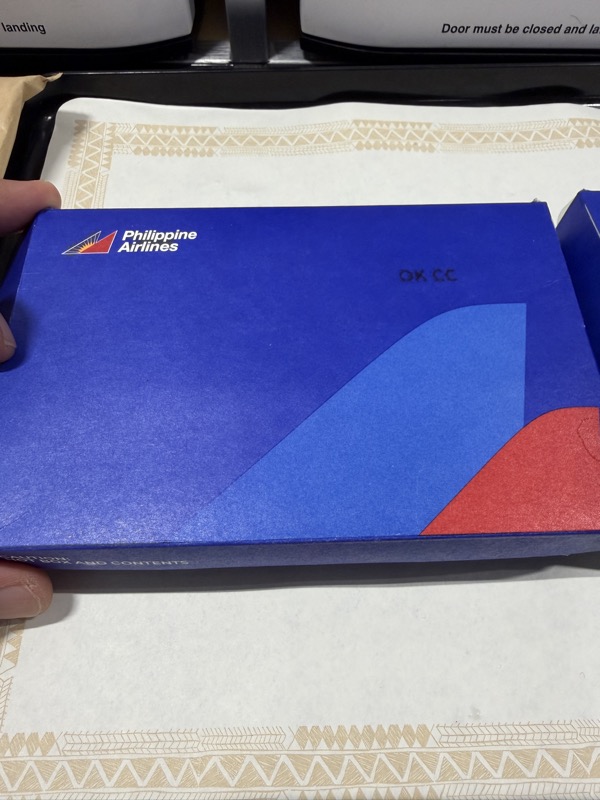 a hand holding a blue box